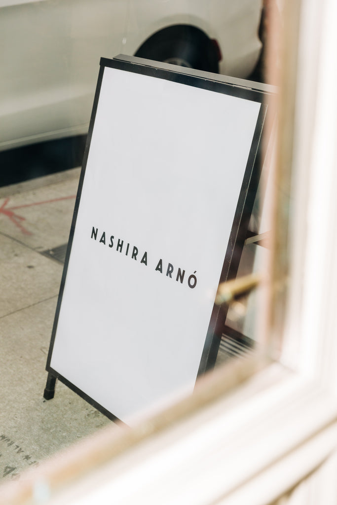Nashira Arno sign on a stand in an indoor setting