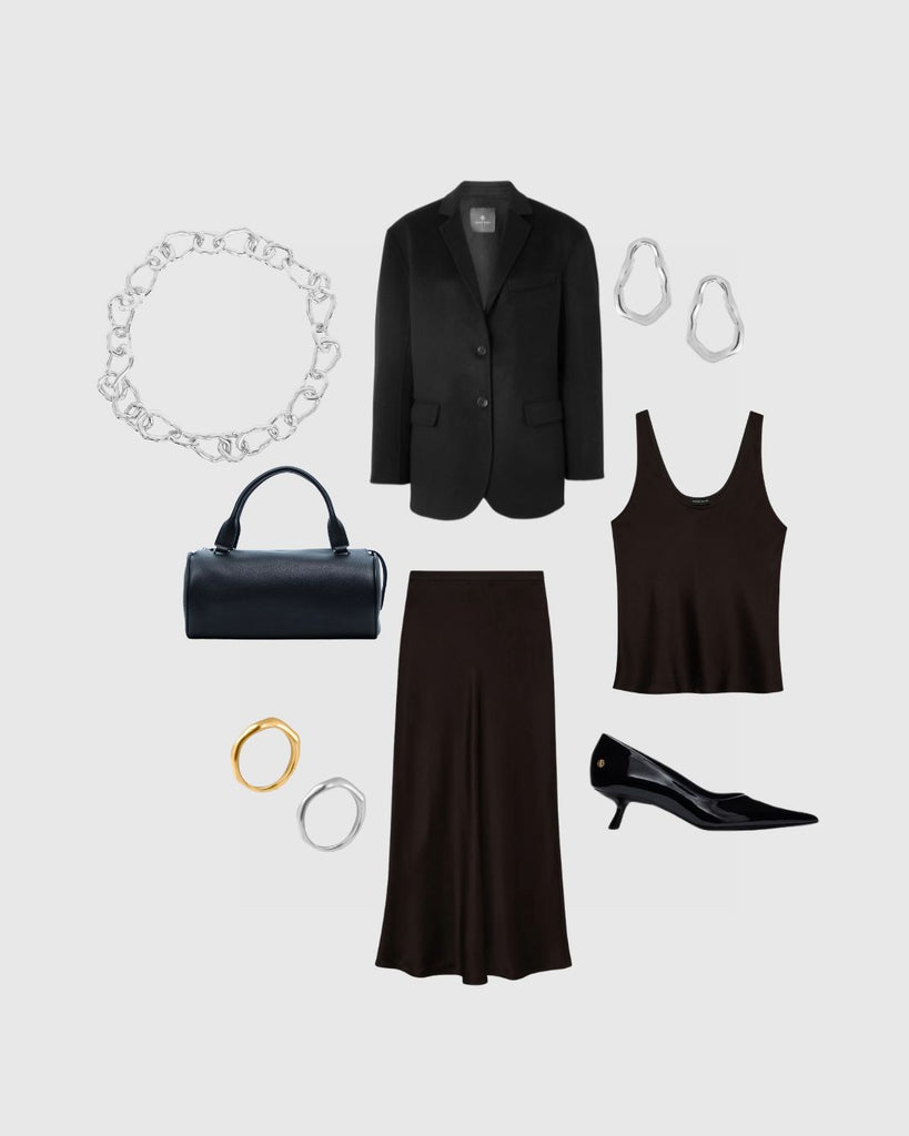 Black outfit with jacket, skirt, tank top, handbag, and accessories on a light gray background