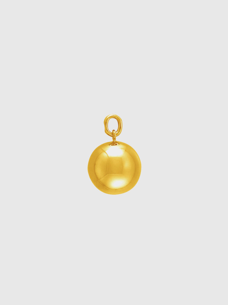 Gold ball pendant charm on a light gray background