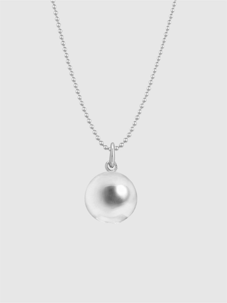 Silver necklace with a round pendant on a light gray background
