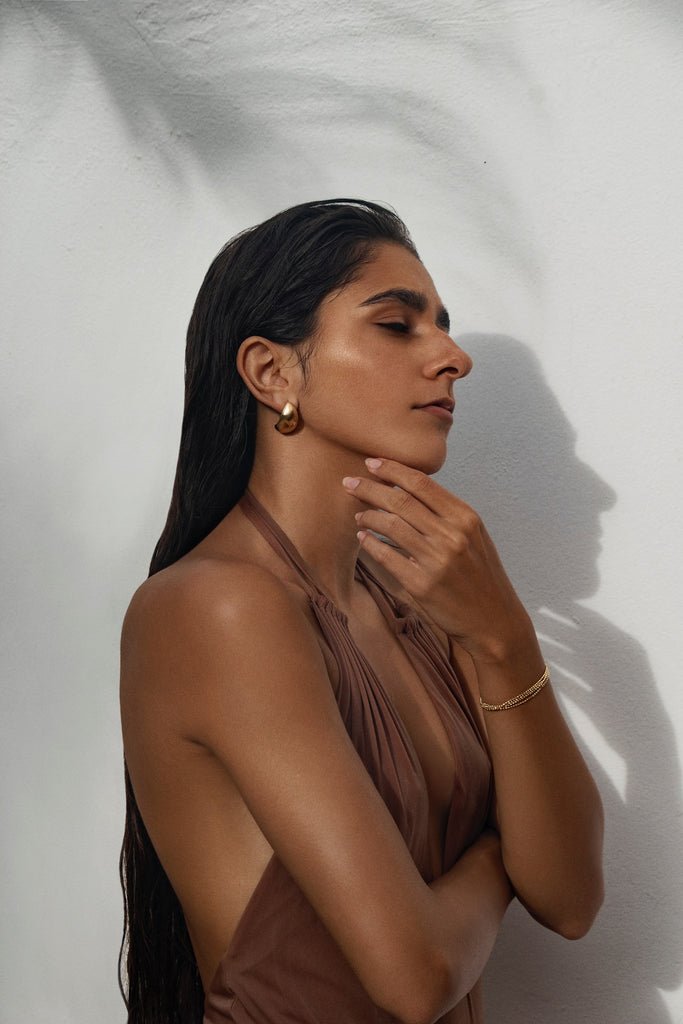 nashira-arno-wave-stud-statement-earrings-gold-main