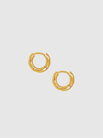 Gold hoop earrings on a light gray background